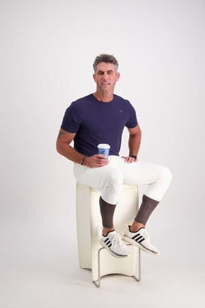 Gallant Equestrian Mens Short Sleeve Tee in navy on seated model, showcasing tailored fit and lightweight design.
