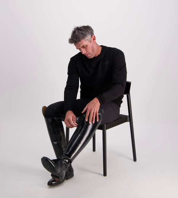 Gallant Equestrian Essentials seated on chair