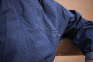 Blue raincoat with 'Gillan' branding on a blurred background