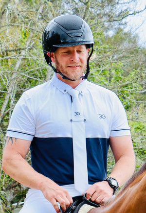 Mens show shirt in white and navy with button-down collar and tie holder worn by male equestrian rider