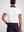 Mens polo shirt paired with breeches, back view showing tailored fit, perfect for equestrians and casual outings.