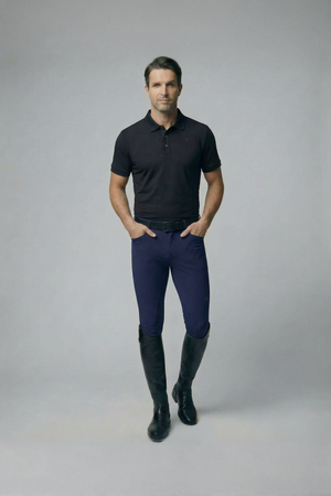 Male model wearing navy mens breeches with knee only silicone grip and black riding boots