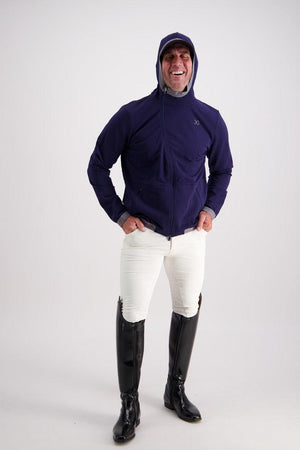 Man wearing Gallant Equestrian Mens Equestrian Hoodie paired with jodhpurs, showing asymmetrical zip and elastic webbing hood, ideal for activewear.