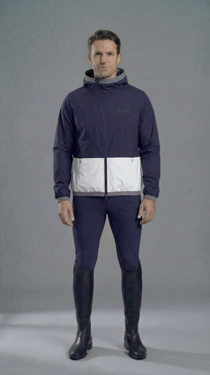 Men's navy equestrian rain jacket with slim fit, elasticated hood, and asymmetrical zip designed for riding.