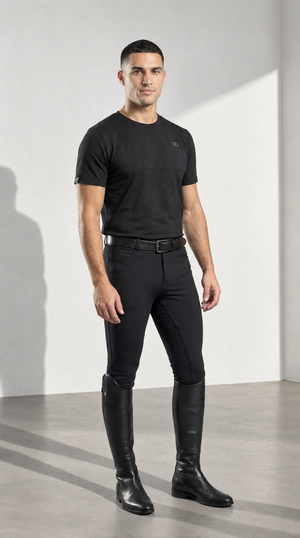 Mens Breeches in black stretch fabric, worn with a subtle textured full-seat grip and tall black riding boots.