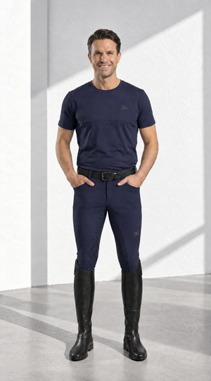 Mens Breeches in dark navy stretch fabric, with a close fit, subtle logo details and black full-length riding boots.