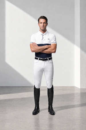 Mens Competition Breeches in white stretch fabric, close-fitting with black knee-high riding boots and subtle logo details.